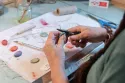 mains qui fabriquent un bijou à planter modibulle